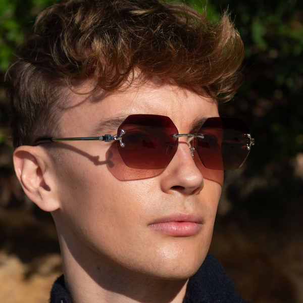 Ung mand med rammeløse solbriller i walnut brown nuance